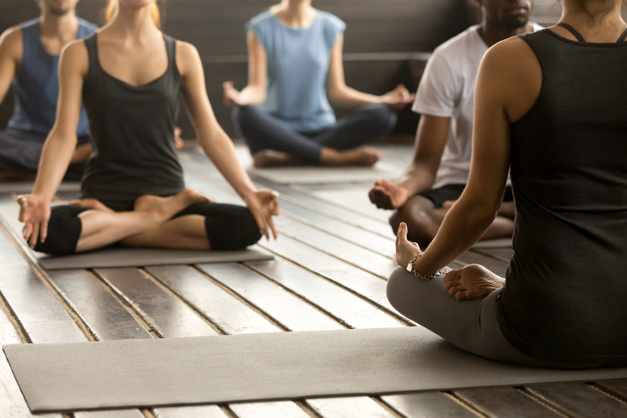 A Group of People Sitting on Yoga Mats